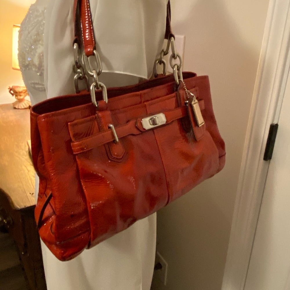 Red patent coach purse